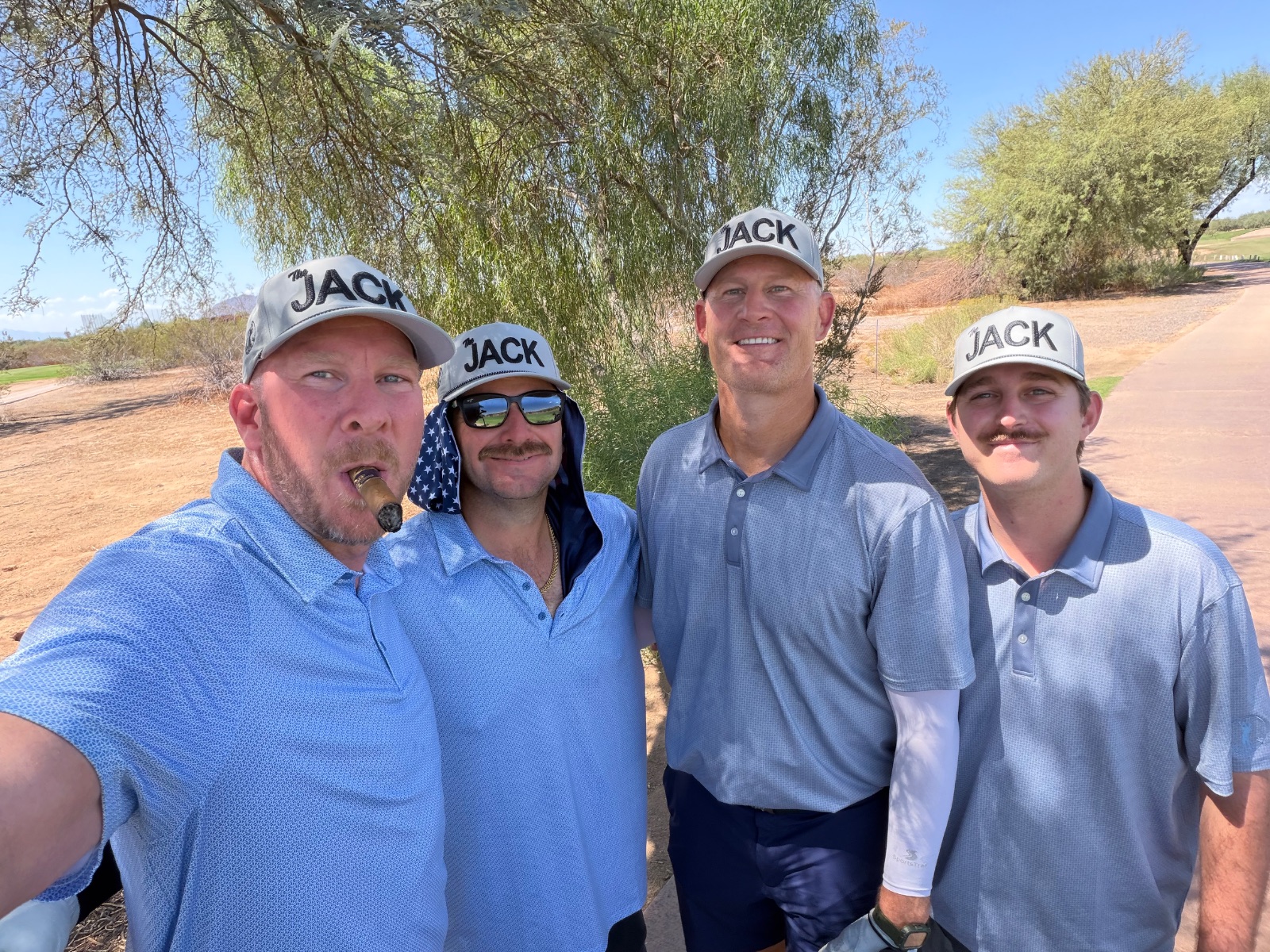 Saturday foursome — cigars, JACK hats, and one neck flap
