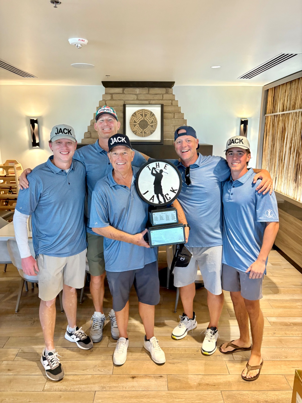 Team Hudson and the hardware — a founder's son holding his family's cup